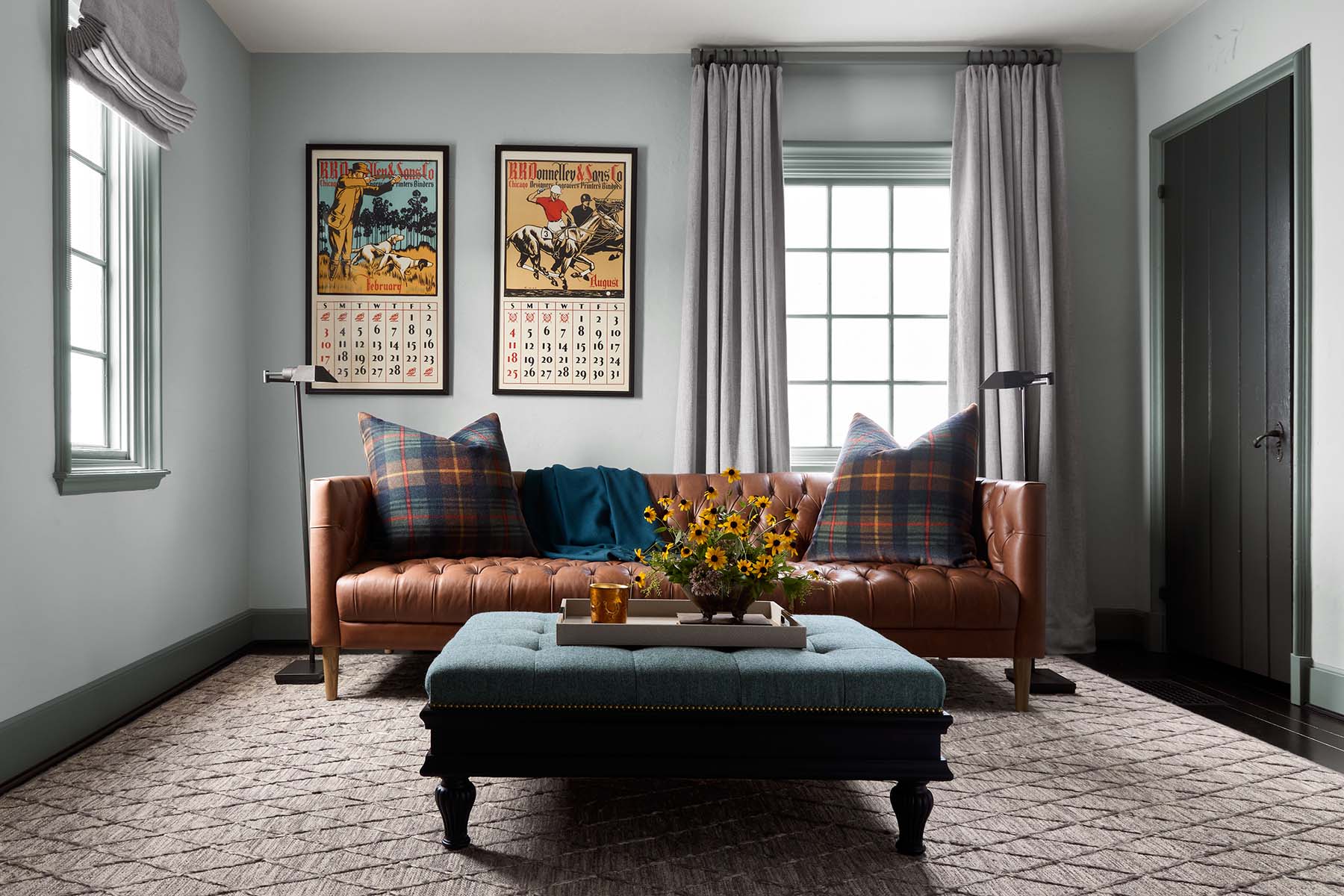 Cozy living room with a sofa, table, and decorative artwork on walls.