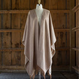 the Alicia Adams Alpaca Classic Cape, a timeless piece available in solid or herringbone patterns. With over 100 colors to choose from, it's perfect for any style preference. The cape effortlessly layers over sweaters and jackets, making it a must-have staple in every wardrobe.  This color is Cognac