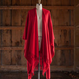the Alicia Adams Alpaca Classic Cape, a timeless piece available in solid or herringbone patterns. With over 100 colors to choose from, it's perfect for any style preference. The cape effortlessly layers over sweaters and jackets, making it a must-have staple in every wardrobe.  This color is Red