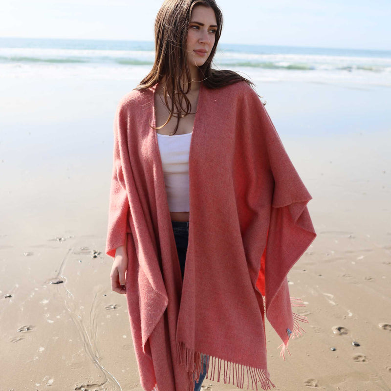 the Alicia Adams Alpaca Classic Cape, a timeless piece available in solid or herringbone patterns. With over 100 colors to choose from, it's perfect for any style preference. The cape effortlessly layers over sweaters and jackets, making it a must-have staple in every wardrobe.  